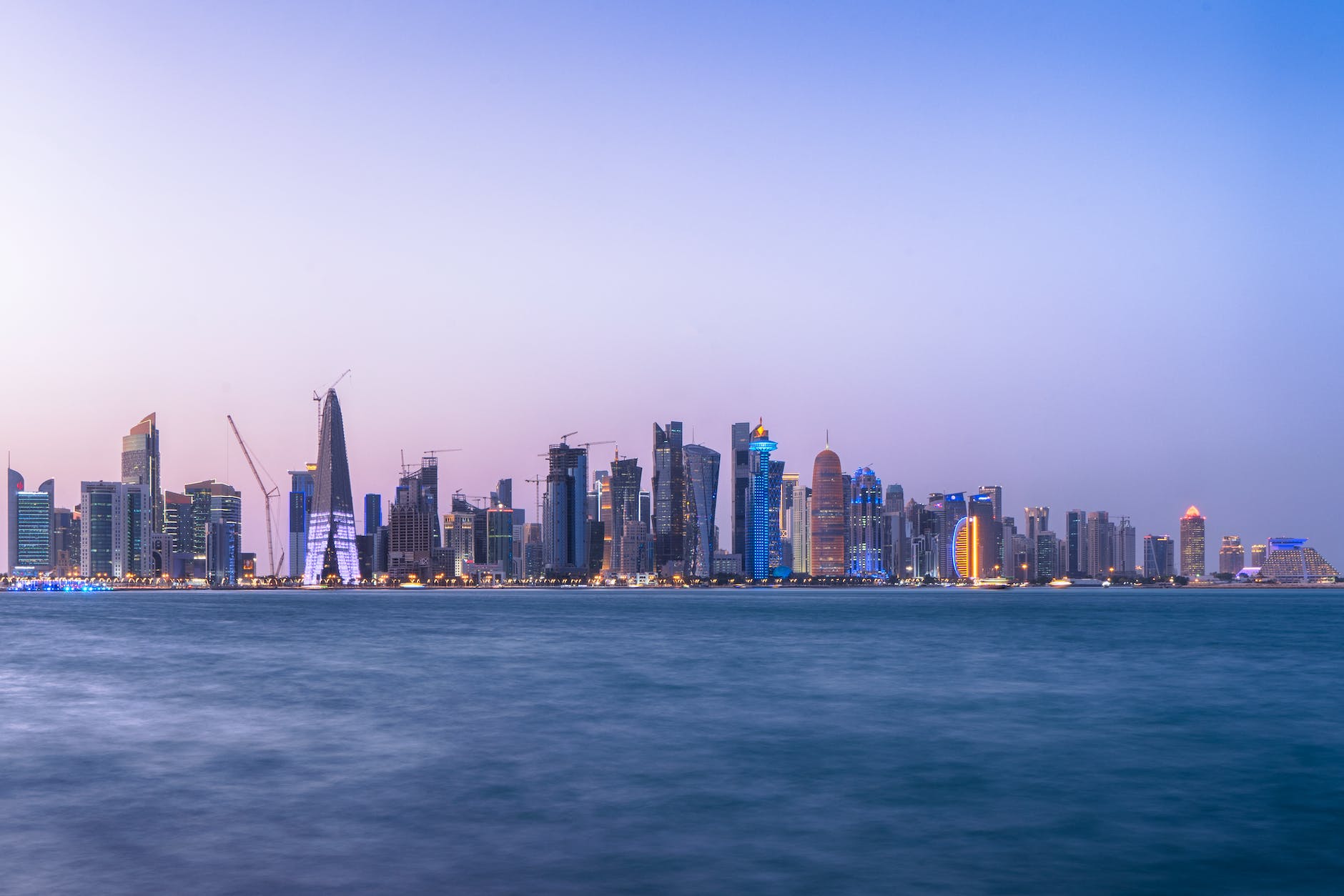 city skyline near body of water in doha qatar
